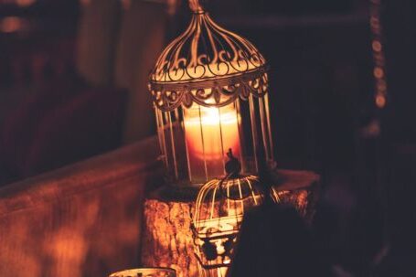 Memorable Ambiance - Photo Of Brown Metal Cage With Lighted Candle