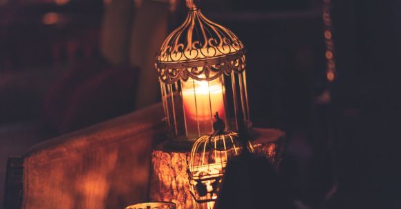 Memorable Ambiance - Photo Of Brown Metal Cage With Lighted Candle