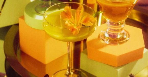 Profitable Cocktails - variety of cocktail glasses with different shape, Different cocktails or longdrinks garnished with fruits on the bar table