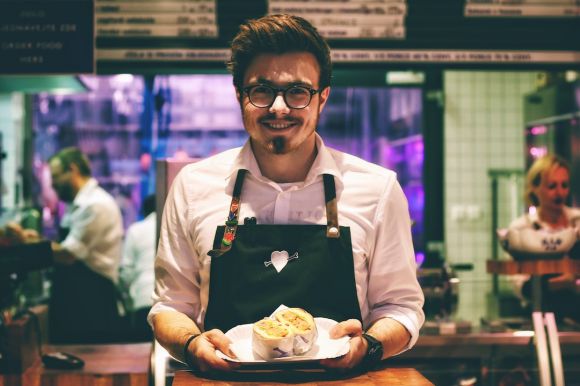 Restaurant Staff - man holding fish dish on plate