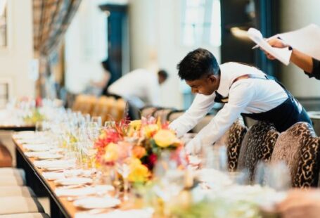 Restaurant Staff - man in white top standing next to table