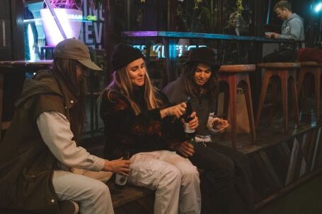 Key Steps: Opening Bar. - Young Women Sitting Outside a Bar