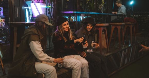 Key Steps: Opening Bar. - Young Women Sitting Outside a Bar